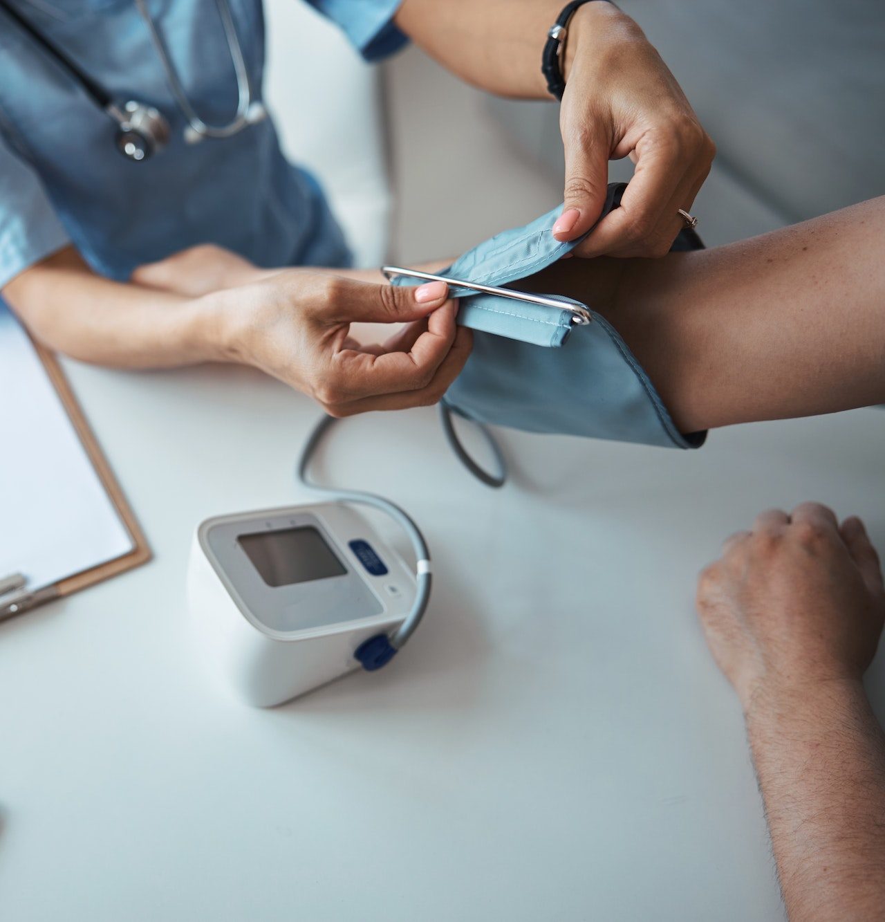 female-doctor-checking-patient-blood-pressure-in-clinic-e1682348846289.jpg